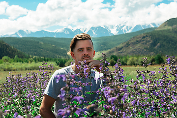 Image showing Man in beautiful wild pink and purple flowers field