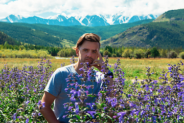 Image showing Man in beautiful wild pink and purple flowers field