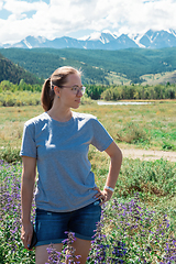 Image showing Happy young woman in beautiful wild pink and purple flowers field