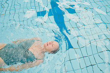 Image showing Elderly woman, swimming and pool with float and cardio training for fitness, wellness and physical health. Senior swimmer, water hydrotherapy workout and physical therapy in retirement for healthcare