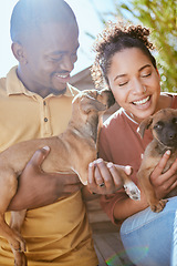 Image showing Pet, face lick and couple with dogs playing, having fun and enjoy quality time together in home backyard. Animal love bond, happiness and owner pet care from happy black woman and man with new puppy