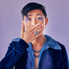 Image showing Surprised, shocked and gay man with makeup in a studio for pride, beauty and gender fluid cosmetics. Lgbtq, queer and homosexual guy with wow, surprise or omg expression isolated by purple background