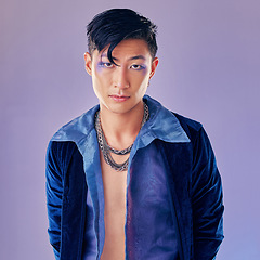 Image showing Art, purple and creative portrait of man with makeup, serious face and self expression. Futuristic disco funk style fashion, male model from Japan and artistic future beauty on studio background.