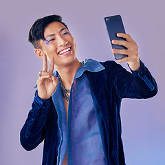 Image showing Man, makeup art and selfie with phone for creative, skin or beauty with happiness against purple backdrop. Happy, model and photo with smartphone with face, cosmetic or fashion by lavender background