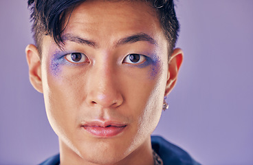 Image showing Punk, artistic and man with makeup on face for metal, rock and trippy identity against a purple studio background. Expression, funky and portrait of Asian model or person in a band with cosmetics