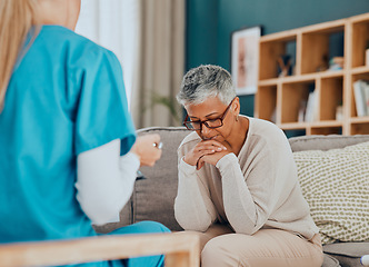 Image showing Talking, healthcare and nurse with sad old woman in home, sitting on sofa and upset after cancer news. Medical care, sickness and senior female with doctor depressed, anxious and worried about health