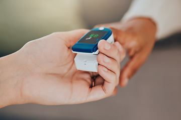 Image showing Oximeter, test and hand of a doctor with a patient for healthcare, medical help and consulting in house. Digital, monitor and reading of health of oxygen in blood and check during a consultation