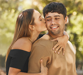 Image showing Happy couple, love and kiss on cheek outdoor in nature park for vacation, adventure and quality time together in summer. Commitment, security and fresh air for healthy marriage with a man and woman