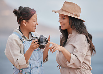 Image showing Photography, happy and friends with a camera for holiday in nature of Mexico together. Smile, travel and photographer with memory on vintage camera with a woman by the sea or ocean for vacation