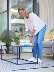 Image showing Black woman, books and portrait of student in living room pick up book or business startup guide for reading. Learning, education and female from Nigeria with textbook on table in home for studying.