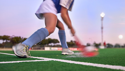 Image showing Sports, hockey and hit with woman on field for training, fitness and goals exercise. Challenge, action or power with shoes of hockey player in stadium for competition, performance and athlete workout