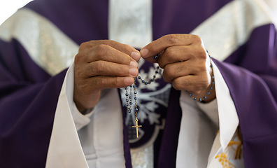 Image showing Priest, pastor and man hands with rosary with cross in church, prayer and catholic worship, praying or spiritual respect. Christian preacher, faith beads with crucifix and holy religion for God mercy