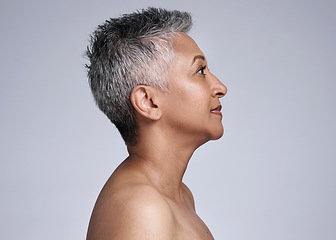 Image showing Mature woman, face and skincare glow on gray studio background in plastic surgery, body dermatology or cosmetology preparation. Indian beauty model, grey hair or makeup cosmetics on mock up profile