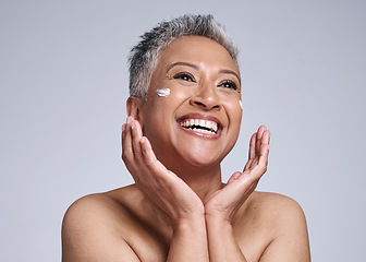 Image showing Skincare, cream and senior black woman in studio with happy facial, makeup cleaning or sunscreen product for marketing mock up. Beauty, anti aging and face of old woman for dermatology or cosmetics