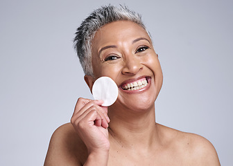 Image showing Happy senior woman, portrait cotton for skincare and cleaning face in facial dermatology. Remove makeup with pad, elderly lady in studio with gray background and natural hygiene for spa mock up