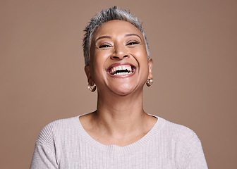 Image showing Black woman, beauty and happiness with a senior laughing about funny joke or memory on a brown studio background. Face portrait of a mature model posing for cosmetics, makeup or fashion mockup