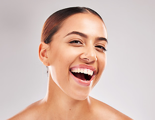 Image showing Woman, face and smile with teeth for dental care, hygiene or skincare against grey studio background. Portrait of happy female smiling in satisfaction for oral cosmetics, mouth or gum care treatment