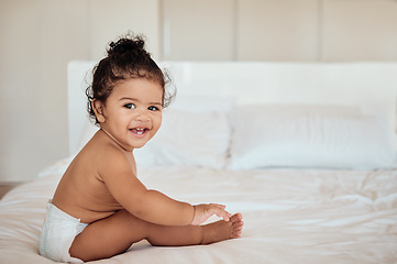 Image showing Happy, health and baby on bed portrait in diaper with wellness, cheerful and cute smile in home. Relax, happiness and healthy toddler in disposable napkin and barefoot in house bedroom.