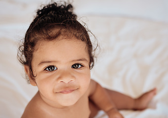 Image showing Face, baby and portrait with a newborn infant girl sitting in a cot or crib in the bedroom of her home from above. Children, innocent and cute with an adorable little female kid in her house closeup