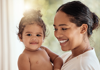 Image showing Mother, baby and happiness of family with a smile, love and care while together in house for quality time and bonding. Face of a woman and child together for security and safety with lens flare