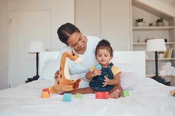 Image showing Mother, baby and toys for learning, education and development with building blocks and teddy bear on a bed in a home bedroom. Woman and child together for bonding, love and support while playing