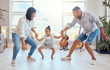 Image showing Family, dance and child with mom and dad having fun, bonding and enjoying weekend. Movement, love and young girl dancing with mother and father in living room for wellness, joy and happiness in home