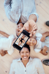 Image showing Top view, family and phone selfie in home for happy memory together on floor. Love, care and 5g mobile picture of happy mother, father and children bonding for social media, internet or online post.