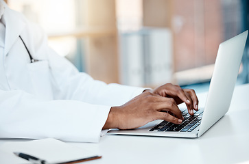 Image showing Doctor, hands and typing on laptop in office, working on research or online consultation. Healthcare, computer and black male physician writing patient report, data record or checking medical email.