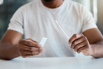 Image showing Covid, test and hands of a man with a medical kit for healthcare and safety from a virus at a table in a hospital. Corona, health care and sick person with results from a pcr sample at a clinic