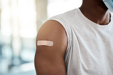 Image showing Black man, covid vaccine and plaster on arm for safety, healthcare and prevention or government compliance for health and wellness. Bandaid, first aid and patient injection for covid 19 virus