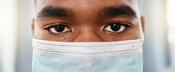 Image showing Black man, covid face mask and medical doctor eyes for facial protection from disease, bacteria and germs in hospital. Healthcare safety policy, wellness compliance and covid 19 virus health security