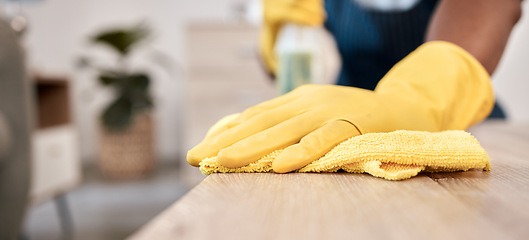 Image showing Wiping, cloth and hands of a man on a table cleaning the dust with gloves in a house. Bacteria, service and cleaner with product to clean for disinfection of a surface, desk or apartment for health