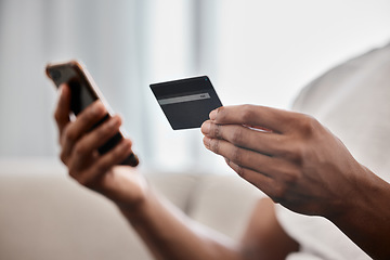 Image showing Online shopping, payment and hands with a credit card and phone for ecommerce, banking and easy finance from the sofa. Sale, discount and man with technology and debit card for retail shopping on web