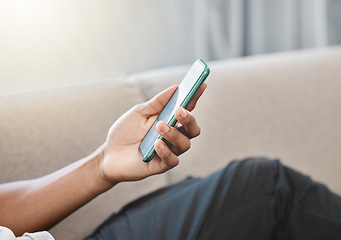 Image showing Communication, online and hand typing on phone browsing internet, social media and network. Technology, communication and person relaxing on sofa at home on mobile app, texting and using smartphone