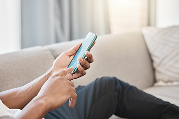 Image showing Mobile phone, communication and 5g network, man on living room couch for social media app to chat or streaming video online. Hand of male on smartphone for networking, reading news or internet search