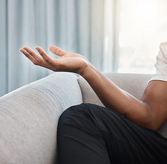 Image showing Hand, yoga and meditation with a black man on the sofa, sitting in the living room of his home alone. Wellness, zen and meditate with male yogi in his house to relax for mental health or balance