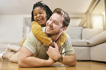 Image showing Family, children and fun with a foster father and girl having fun together on the living room floor of their home together. Love, smile and happy with a man and adopted daughter bonding in a house