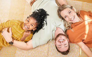 Image showing Happy, family and adoption portrait top view of caucasian mother and dad with black kid in house. Relax, interracial and smile of child together with foster mom and father in joyful home.