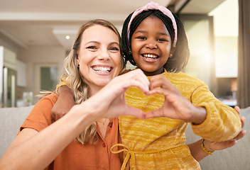 Image showing Heart sign, hand and adoption with girl and mother with icon, love emoji and happy together in home. Family, smile and hand gesture, happiness and portrait on sofa in family home on the weekend