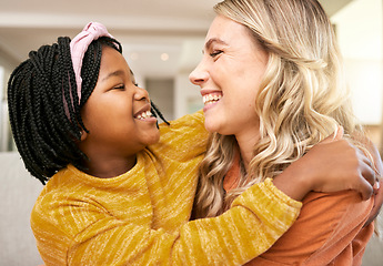 Image showing Mother, adopted and daughter bonding or hugging with love, care and affection for childhood embrace. Diverse woman and foster little girl hugging and having fun while in the family home