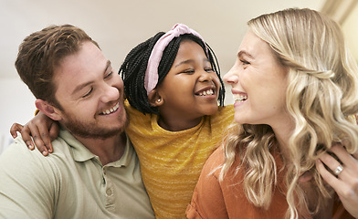 Image showing Family diversity and adoption with a foster mother, father and girl bonding in the living room of their home. Trust, love and smile with a man, woman and daughter happy together in their house