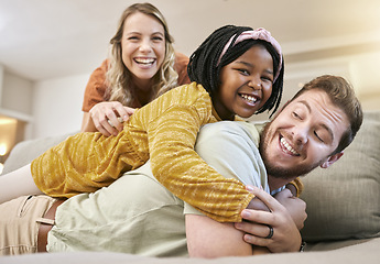 Image showing Family, adoption and love with a mother, father and foster child together on living room couch for fun, happiness and bonding. Portrait, smile and trust of man, woman and girl share hug for sopport