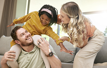 Image showing Bonding, diversity and child with parents in foster care for love, happy and safety in a family home. Playful, smile and father, mother and African girl playing in an interracial house after adoption