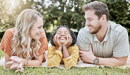 Image showing Family, diversity and children with foster parents and adopted daughter together in a park during summer. Kids, love and adoption with a mother, father and happy girl bonding outdoor in nature