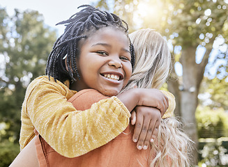 Image showing Mother, interracial adoption and carry girl in park in summer sunshine, happiness and love outdoor. Happy black child, white mom and hug together in nature with smile, embrace and care with diversity