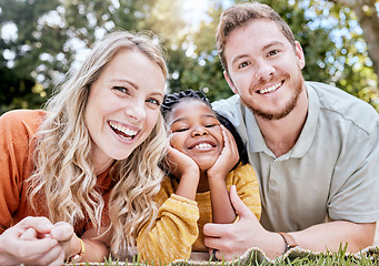 Image showing Adoption, mother and father in nature as a happy family relaxing on a picnic bonding in summer holidays. Interracial, portrait and healthy mom with dad enjoying a lovely vacation with a girl child