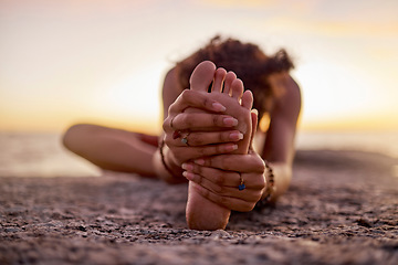 Image showing Stretching, peace and feet of a woman on beach for yoga, training and exercise during sunset. Fitness, sand and legs of girl doing warm up before workout or pilates for wellness and relax by the sea