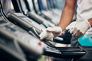 Image showing Cleaning, treadmill and sanitizing equipment in gym for bacteria, germs or protection from covid. Disinfection, sanitizer and closeup of cleaner wiping running machine for fitness in sports center.