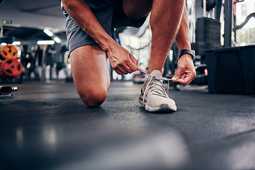 Image showing Hands, gym and man tie shoes preparing for training, running or exercise. Sports, fitness or male athlete in health studio getting ready for cardio, workout or bodybuilding practice in fitness center