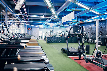Image showing Empty gym, equipment and studio for fitness, exercise and sports or wellness training indoors. Treadmill, machines and health center for workout, athletics and motivation for race or marathon